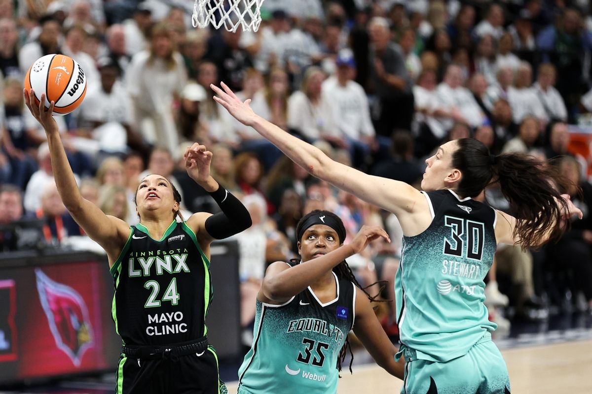 Oct 18, 2024; Minneapolis, Minnesota, USA; Minnesota Lynx forward Napheesa Collier (24) shoots as New York Liberty forward Jonquel Jones (35) and forward Breanna Stewart (30) defend during the second half of game four of the 2024 WNBA Finals at Target Center. Mandatory Credit: Matt Krohn-Imagn Images