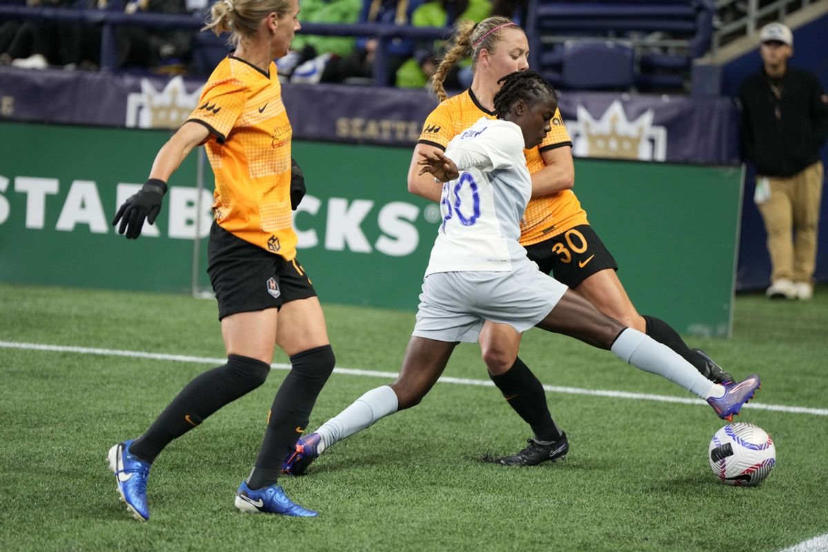 Oct 18, 2024; Seattle, Washington, USA; Seattle Reign FC forward Nerilia Mondesir (30) reaches for the ball against Houston Dash forward Avery Patterson (30) during the second half at Lumen Field. Mandatory Credit: Stephen Brashear-Imagn Images