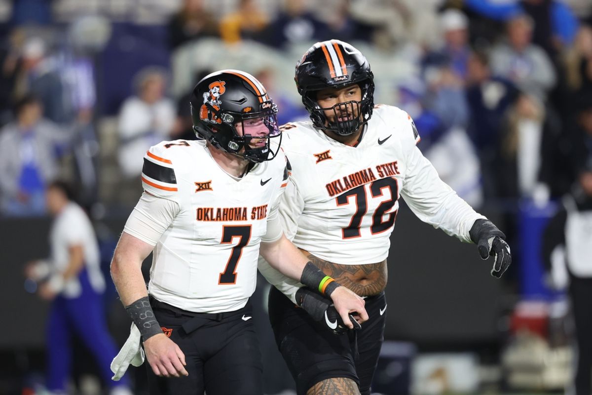 Oct 18, 2024; Provo, Utah, USA; Oklahoma State Cowboys quarterback Alan Bowman (7) and offensive lineman Isaia Glass (72) speak after a play against the Brigham Young Cougars during the third quarter at LaVell Edwards Stadium. Mandatory Credit: Rob Gray-Imagn Images