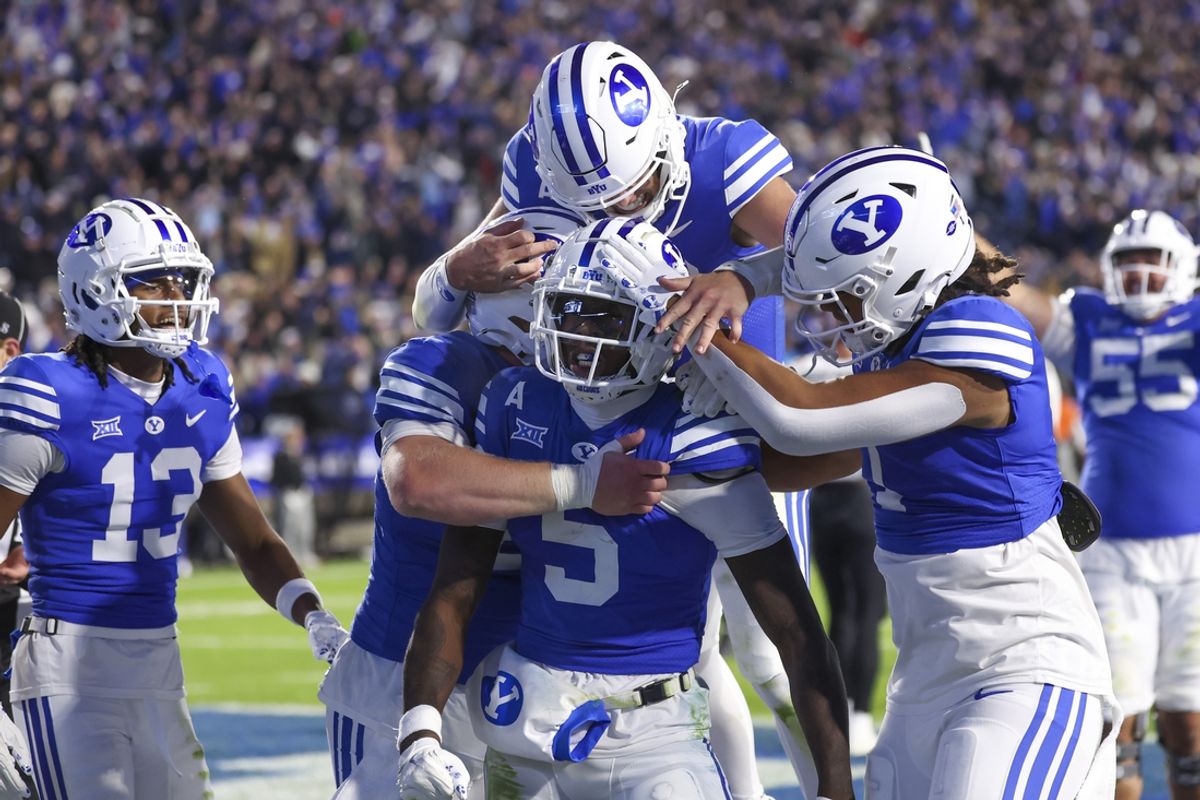 Oct 18, 2024; Provo, Utah, USA; Brigham Young Cougars wide receiver Darius Lassiter (5) celebrates a touchdown with teammates in the last minute of the game against the Oklahoma State Cowboys at LaVell Edwards Stadium. Mandatory Credit: Rob Gray-Imagn Images