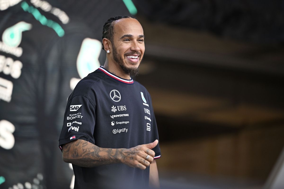 Oct 19, 2024; Austin, Texas, USA; Mercedes AMG Petronas F1 Team driver Lewis Hamilton (44) of Team Great Britain smiles to the crowd during a fan forum before the Sprint Race in the 2024 Formula One US Grand Prix at Circuit of the Americas. Mandatory Credit: Jerome Miron-Imagn Images