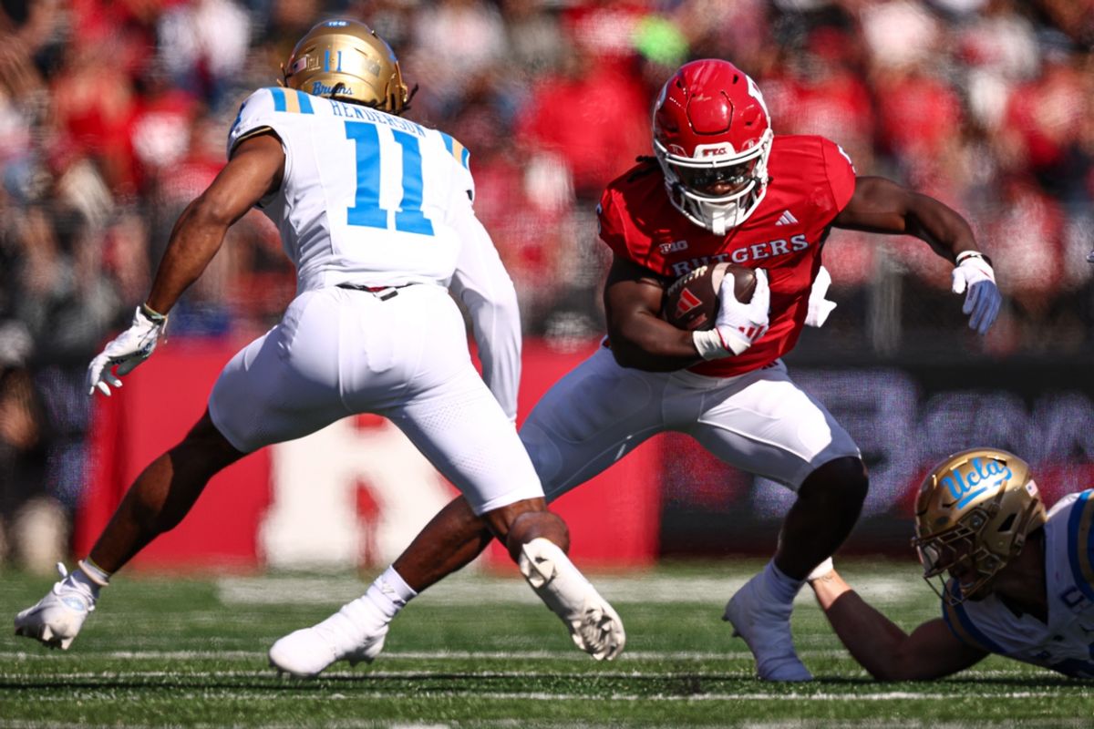 Oct 19, 2024; Piscataway, New Jersey, USA; Rutgers Scarlet Knights running back Kyle Monangai (5) fights for yards as UCLA Bruins defensive back Ramon Henderson (11) pursues at SHI Stadium. Mandatory Credit: Vincent Carchietta-Imagn Images