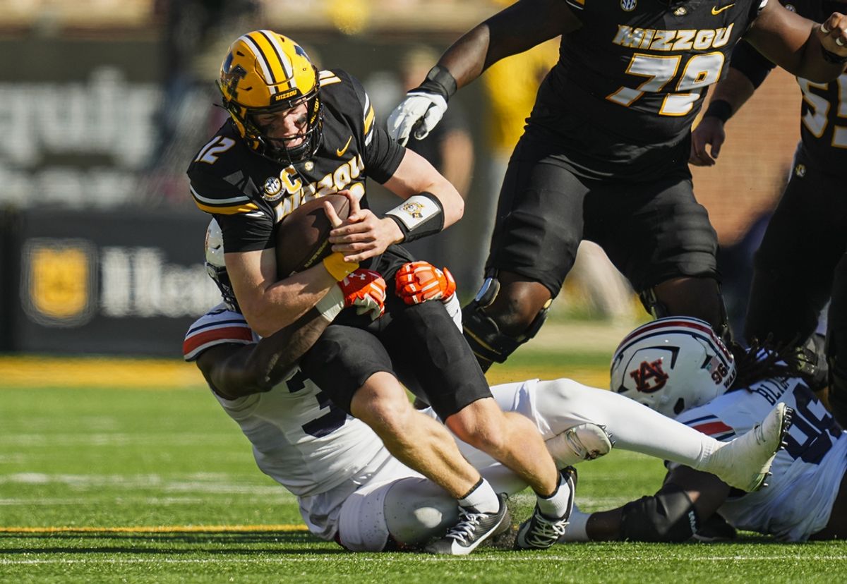 Oct 19, 2024; Columbia, Missouri, USA; Missouri Tigers quarterback Brady Cook (12) is tackled by Auburn Tigers nose tackle Jalen McLeod (35) during the first half at Faurot Field at Memorial Stadium. Mandatory Credit: Jay Biggerstaff-Imagn Images