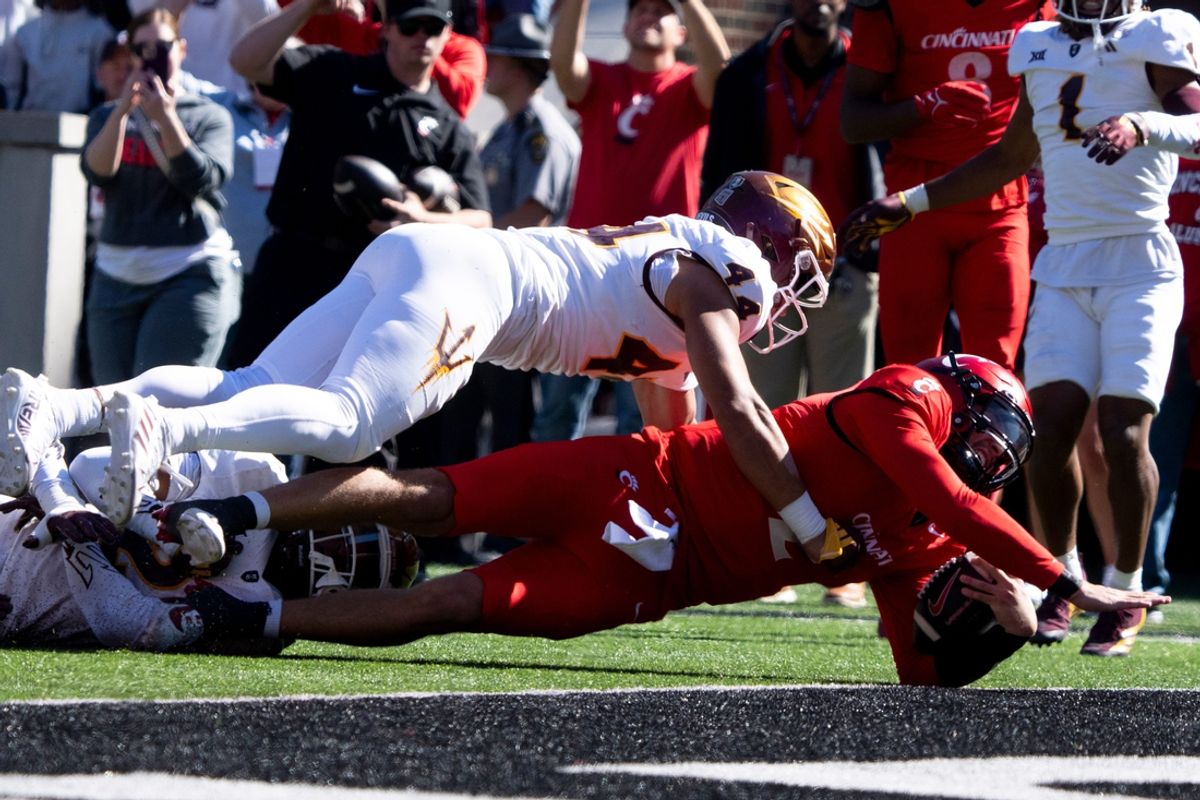 Cincinnati Bearcats quarterback Brendan Sorsby (2) dives for a touchdown as Arizona State Sun Devils defensive back Xavion Alford (2) and Arizona State Sun Devils linebacker Keyshaun Elliott (44) attempt to stop him in the first quarter of the College Football game at Nippert Stadium in Cincinnati on Saturday, Oct. 19, 2024.