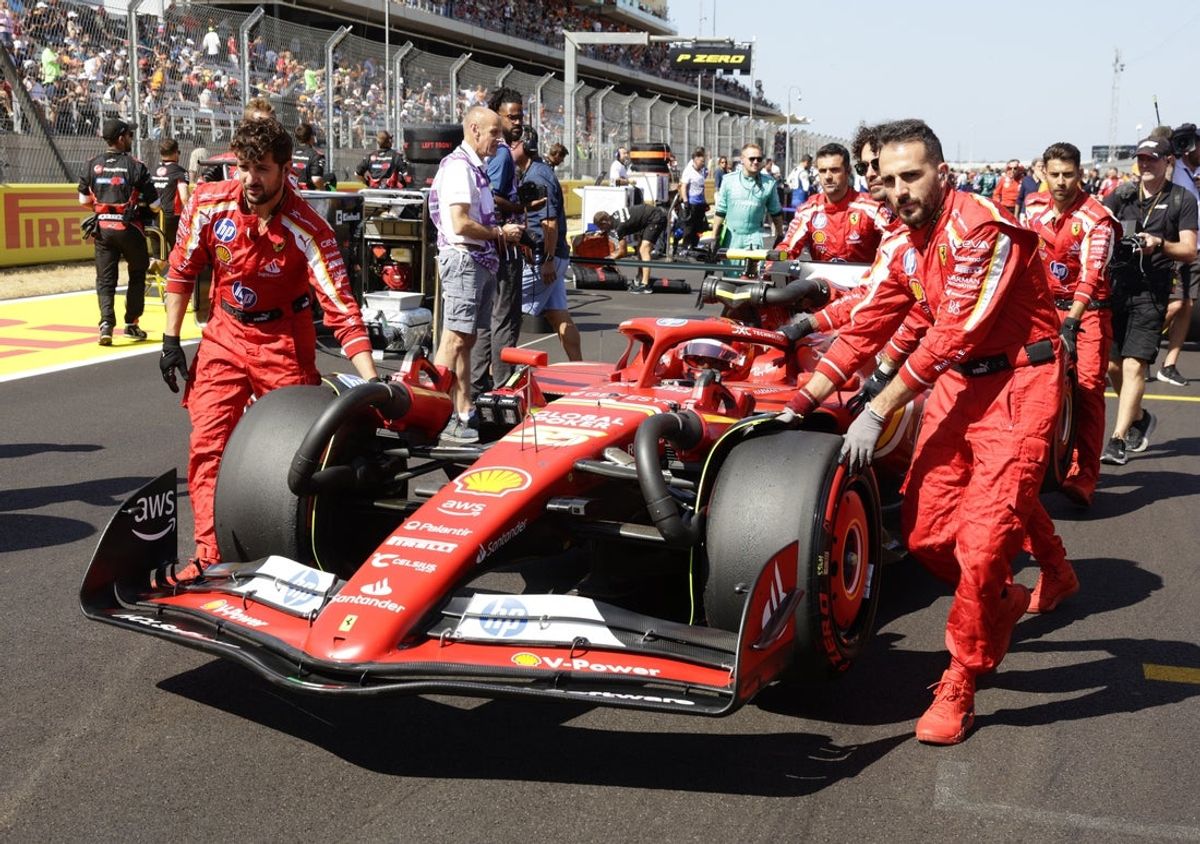 Oct 19, 2024; Austin, Texas, USA;  Carlos Sainz, Jr. of Ferrari gets pushed into the starting line grid before finishing in second place in the Sprint Race at the Formula One US Grand Prix at Circuit of the Americas. Mandatory Credit: Erich Schlegel-Imagn Images