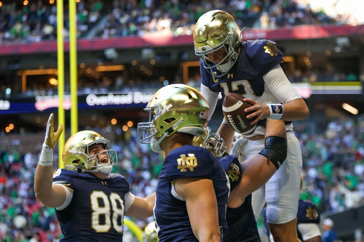 Notre Dame Fighting Irish quarterback Riley Leonard (13) celebrates with teammates after a touchdown against the Georgia Tech Yellow Jackets in the second quarter at Mercedes-Benz Stadium. Mandatory Credit: Brett Davis-Imagn Images