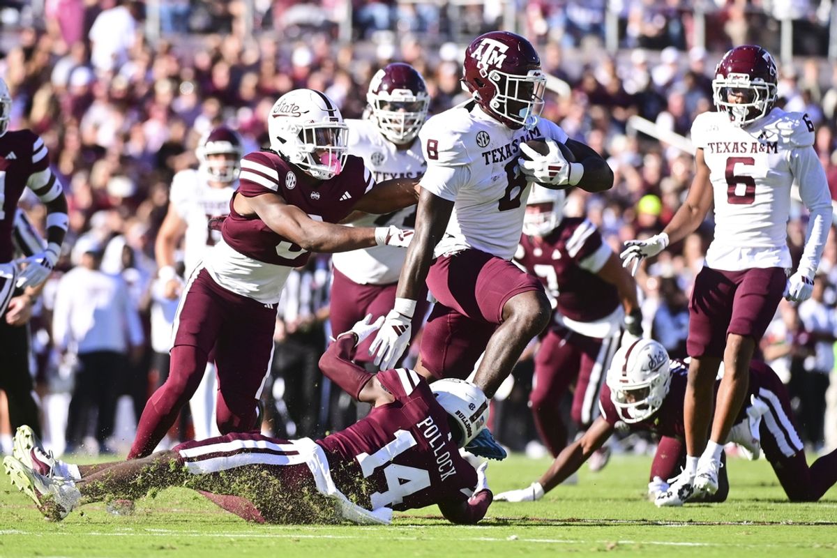 Oct 19, 2024; Starkville, Mississippi, USA; Texas A&M Aggies running back Le'Veon Moss (8) runs the ball against Mississippi State Bulldogs cornerback Brice Pollock (14) during the first quarter at Davis Wade Stadium at Scott Field. Mandatory Credit: Matt Bush-Imagn Images