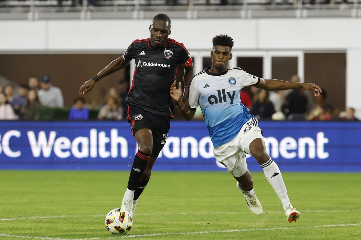 Oct 19, 2024; Washington, District of Columbia, USA; D.C. United forward Christian Benteke (20) battles for the ball against Charlotte FC defender Adilson Malanda (29) in the first half at Audi Field. Mandatory Credit: Geoff Burke-Imagn Images