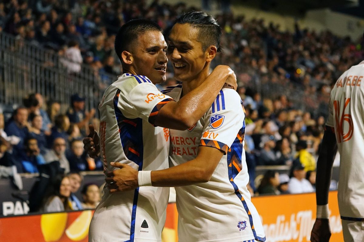 Oct 19, 2024; Philadelphia, Pennsylvania, USA; FC Cincinnati midfielder Yamil Asad (27) celebrates with forward Yuya Kubo (7) after scoring a goal against the Philadelphia Union during the first half at Subaru Park. Mandatory Credit: Gregory Fisher-Imagn Images