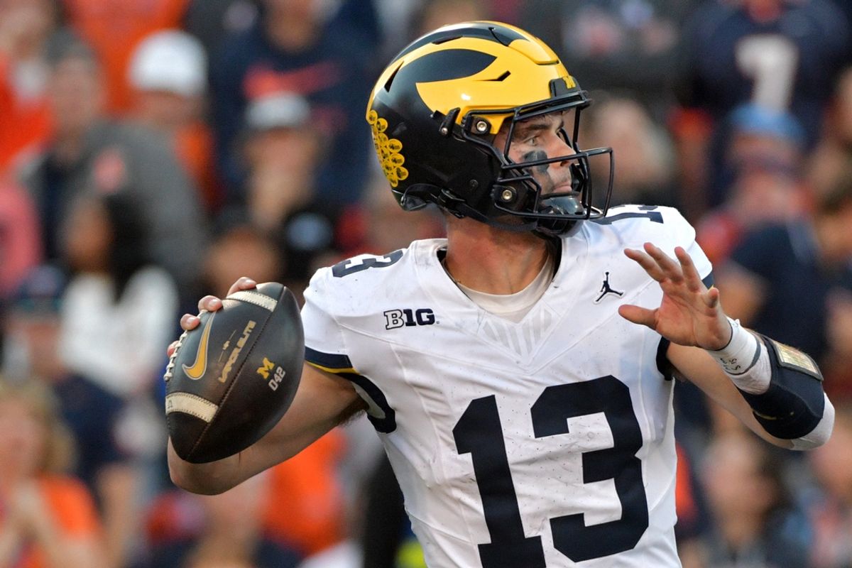 Oct 19, 2024; Champaign, Illinois, USA;  Michigan Wolverines quarterback Jack Tuttle (13) throws against the Illinois Fighting Illini during the second half at Memorial Stadium. Mandatory Credit: Ron Johnson-Imagn Images