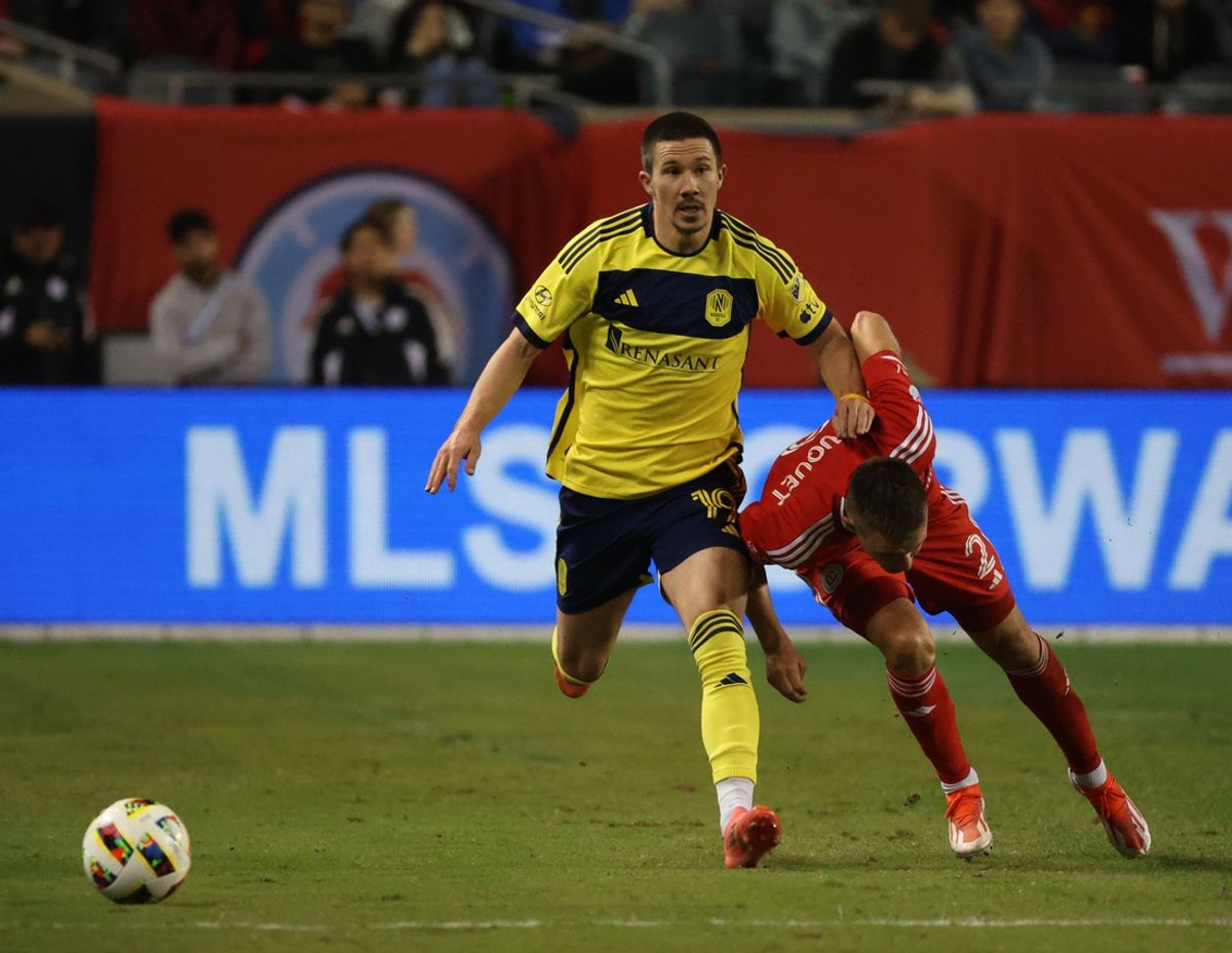 Oct 19, 2024; Chicago, Illinois, USA; Nashville SC midfielder Alex Muyl (19) battles Chicago Fire FC defender Arnaud Souquet (2) for control of a ball during the second half at Soldier Field. Mandatory Credit: Talia Sprague-Imagn Images