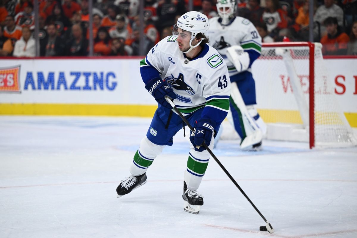 Oct 19, 2024; Philadelphia, Pennsylvania, USA; Vancouver Canucks defenseman Quinn Hughes (43) controls the puck against the Philadelphia Flyers in the second period at Wells Fargo Center. Mandatory Credit: Kyle Ross-Imagn Images