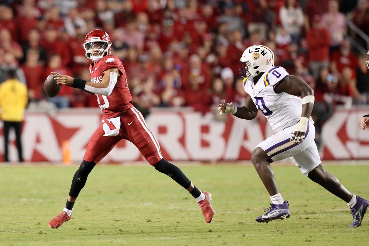 Oct 19, 2024; Fayetteville, Arkansas, USA; Arkansas Razorbacks quarterback Taylen Green (10) passes as LSU Tigers defensive end Paris Shand (0) defends during the second quarter at Donald W. Reynolds Razorback Stadium. Mandatory Credit: Nelson Chenault-Imagn Images