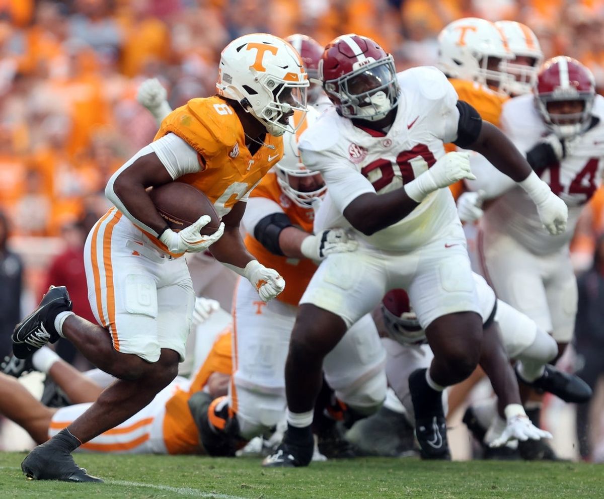 Oct 19, 2024; Knoxville, Tennessee, USA; Tennessee Volunteers running back Dylan Sampson (6) runs the ball against Alabama Crimson Tide defensive lineman Jah-Marien Latham (20) in the third quarter at Neyland Stadium. Mandatory Credit: Alan Poizner-Imagn Images
