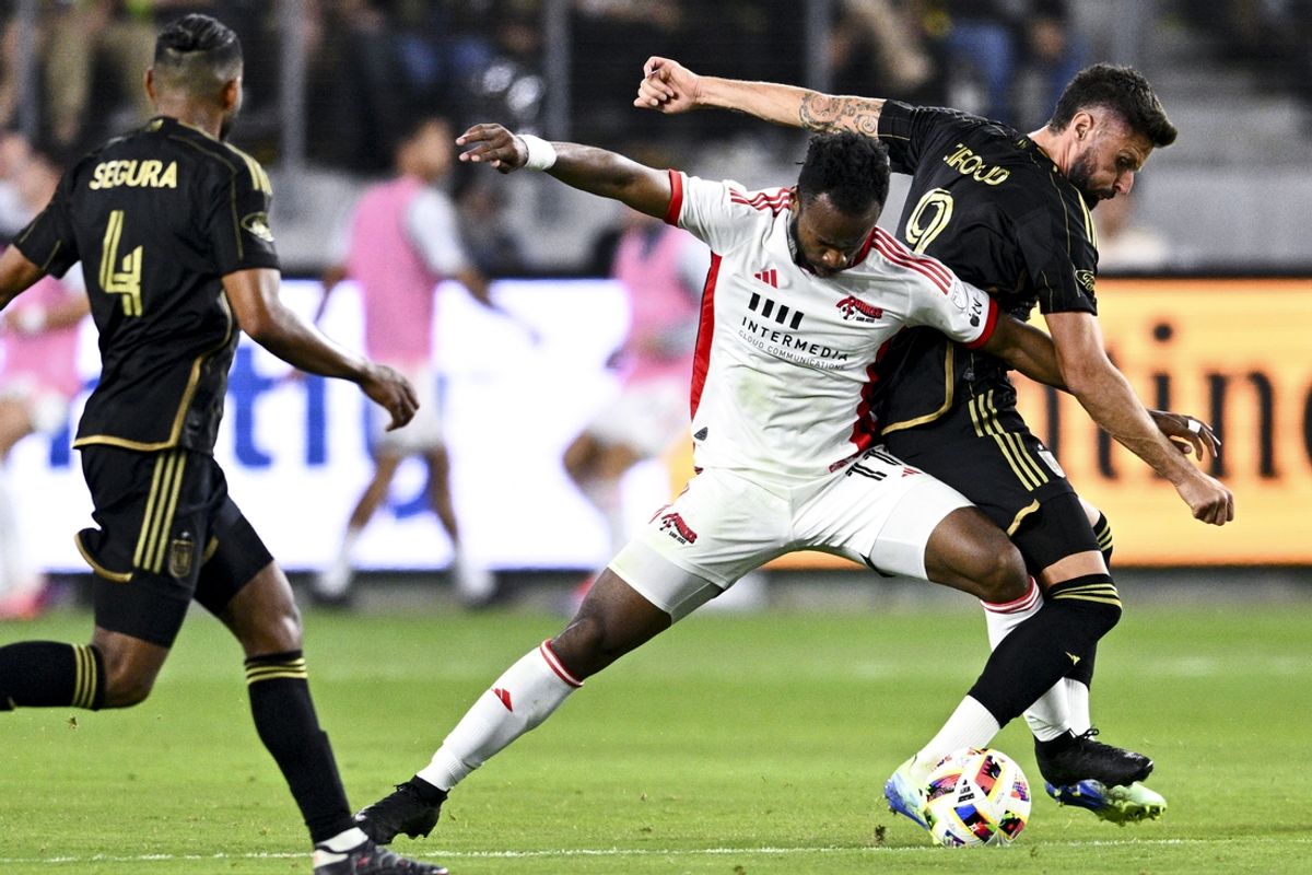 Oct 19, 2024; Los Angeles, California, USA; San Jose Earthquake forward Jeremy Ebobisse (11) and Los Angeles FC forward Olivier Giroud (9) battle for the ball during the first half at BMO Stadium. Mandatory Credit: Kelvin Kuo-Imagn Images