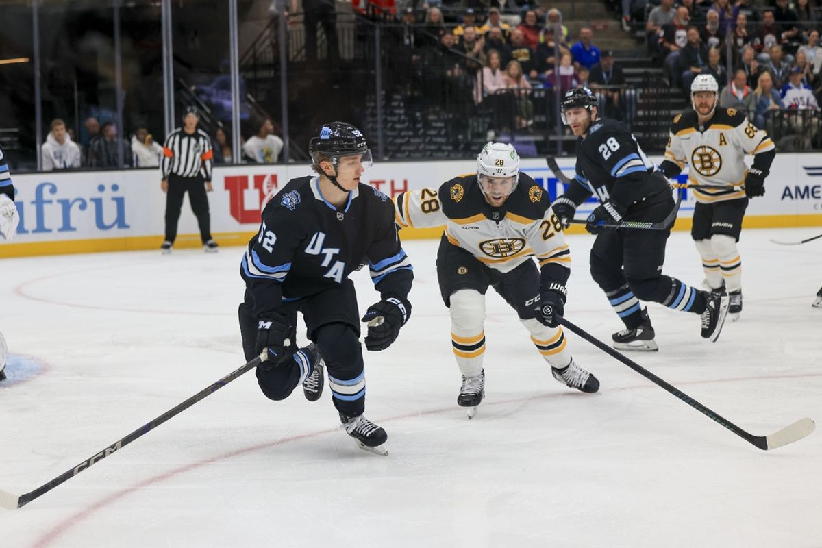 Oct 19, 2024; Salt Lake City, Utah, USA; Utah Hockey ClubAlexander Kerfott (15( fights for the puck first period against Elias Lindholm (28) at Delta Center. Mandatory Credit: Harry Caston-Imagn Images