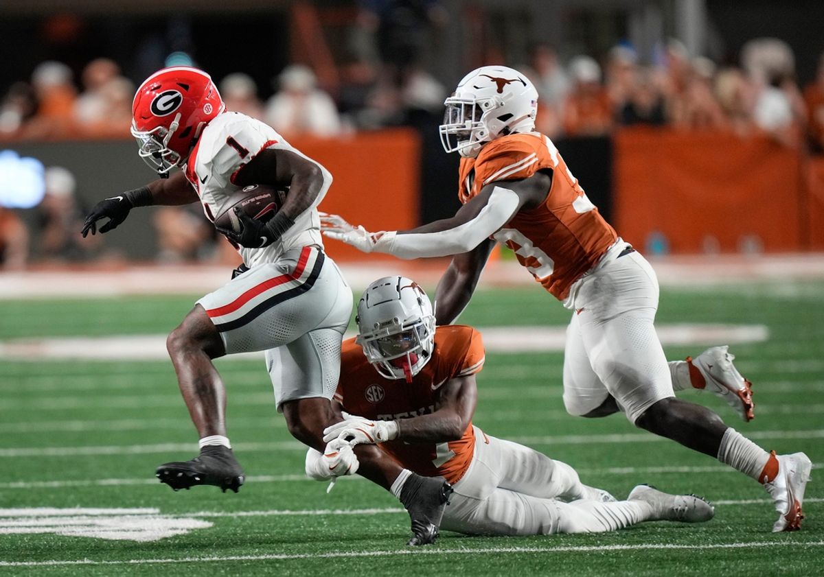 Georgia Bulldogs running back Trevor Etienne tries to get past Texas defenders Jahdae Barron and David Gbenda, right, in the fourth quarter at Darrell K Royal-Texas Memorial Stadium Saturday October 19, 2024.