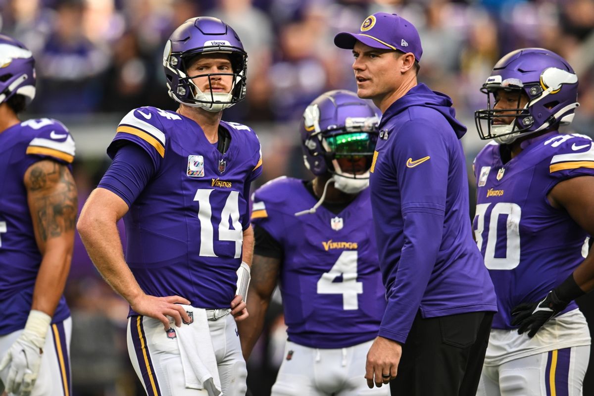 Oct 20, 2024; Minneapolis, Minnesota, USA; Minnesota Vikings quarterback Sam Darnold (14) and Minnesota Vikings head coach Kevin O'Connell and fullback C.J. Ham (right) look on before the game against the Detroit Lions at U.S. Bank Stadium. Mandatory Credit: Jeffrey Becker-Imagn Images
