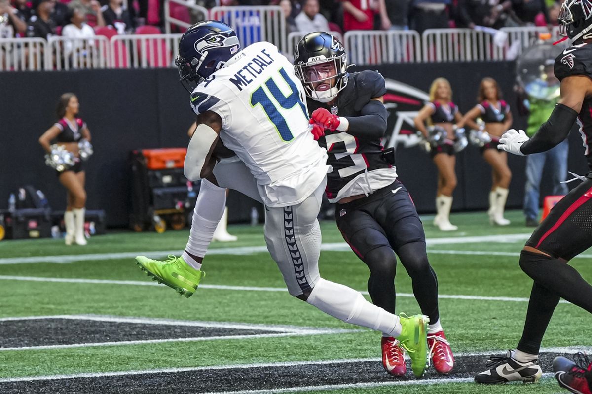 Oct 20, 2024; Atlanta, Georgia, USA; Seattle Seahawks wide receiver DK Metcalf (14) catches a touchdown pass behind Atlanta Falcons safety Jessie Bates III (3) during the first half at Mercedes-Benz Stadium. Mandatory Credit: Dale Zanine-Imagn Images