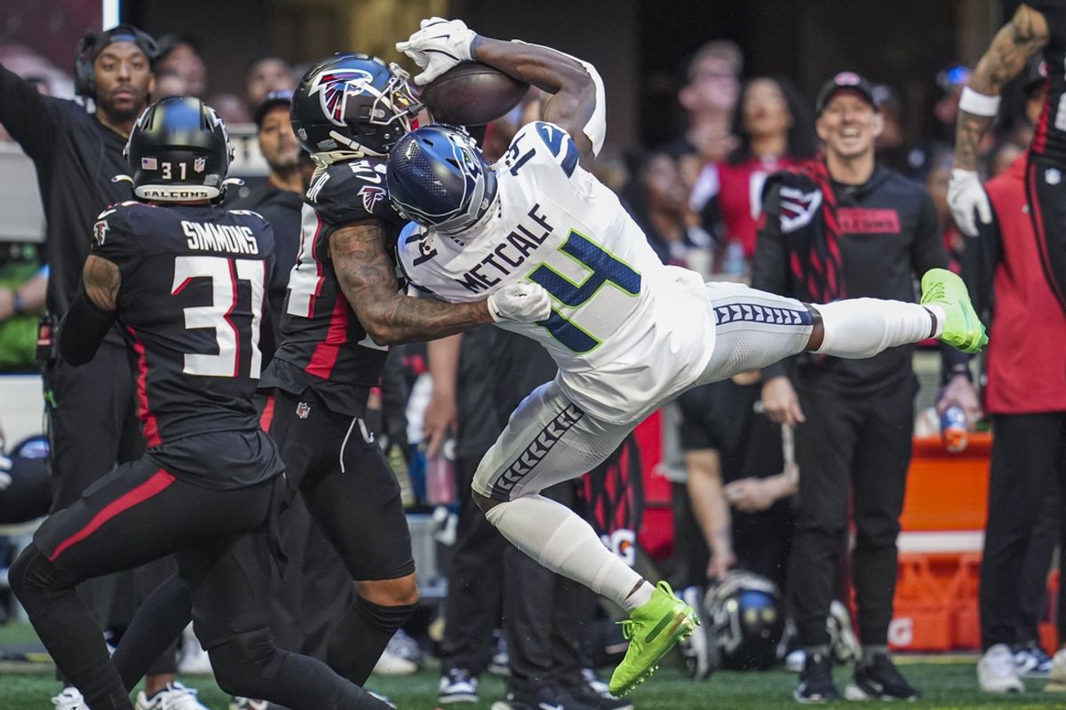 Oct 20, 2024; Atlanta, Georgia, USA; Seattle Seahawks wide receiver DK Metcalf (14) makes a catch over Atlanta Falcons cornerback A.J. Terrell (24) during the first half at Mercedes-Benz Stadium. Mandatory Credit: Dale Zanine-Imagn Images