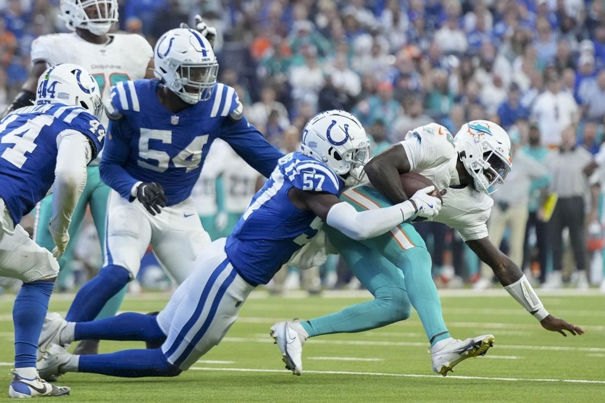 Oct 20, 2024; Indianapolis, Indiana, USA; Indianapolis Colts linebacker Jaylon Carlies (57) sacks Miami Dolphins quarterback Tyler Huntley (18) during a game against the Miami Dolphins at Lucas Oil Stadium. Mandatory Credit: Grace Hollars/IndyStar USA TODAY Network via Imagn Images