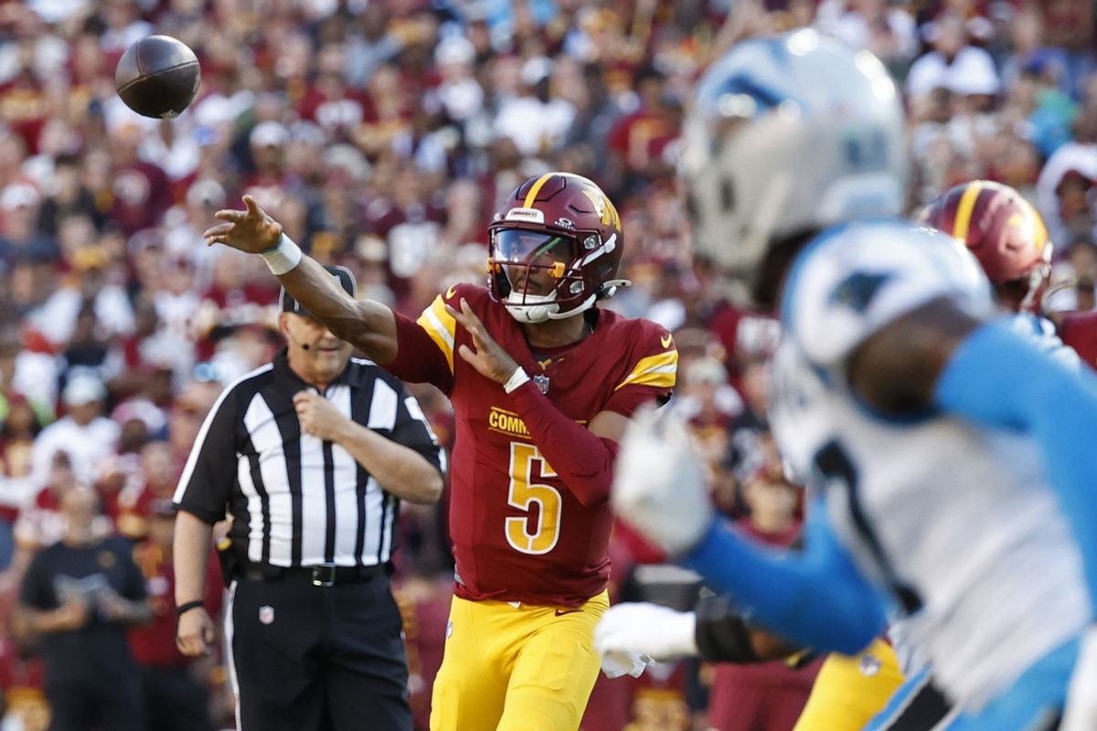 Oct 20, 2024; Landover, Maryland, USA; Washington Commanders quarterback Jayden Daniels (5) passes the ball against the Carolina Panthers during the first quarter at Northwest Stadium. Mandatory Credit: Geoff Burke-Imagn Images