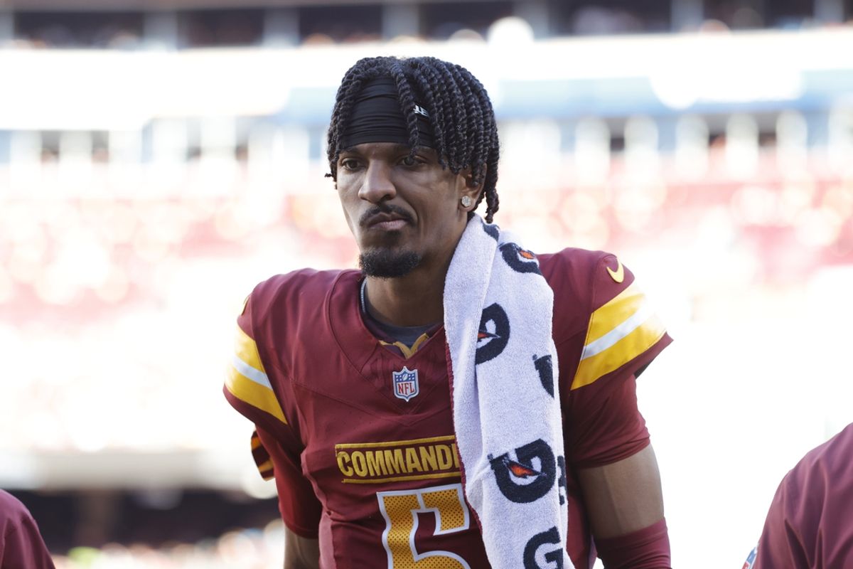 Oct 20, 2024; Landover, Maryland, USA; Washington Commanders quarterback Jayden Daniels (5) walks off the field during the first quarter after an injury against the Carolina Panthers at Northwest Stadium. Mandatory Credit: Amber Searls-Imagn Images