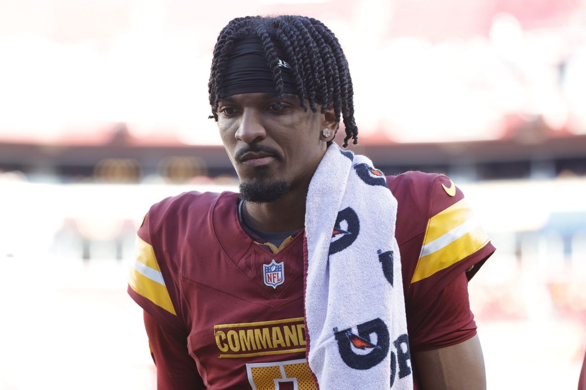 Oct 20, 2024; Landover, Maryland, USA; Washington Commanders quarterback Jayden Daniels (5) walks off the field during the first quarter after an injury against the Carolina Panthers at Northwest Stadium. Mandatory Credit: Amber Searls-Imagn Images