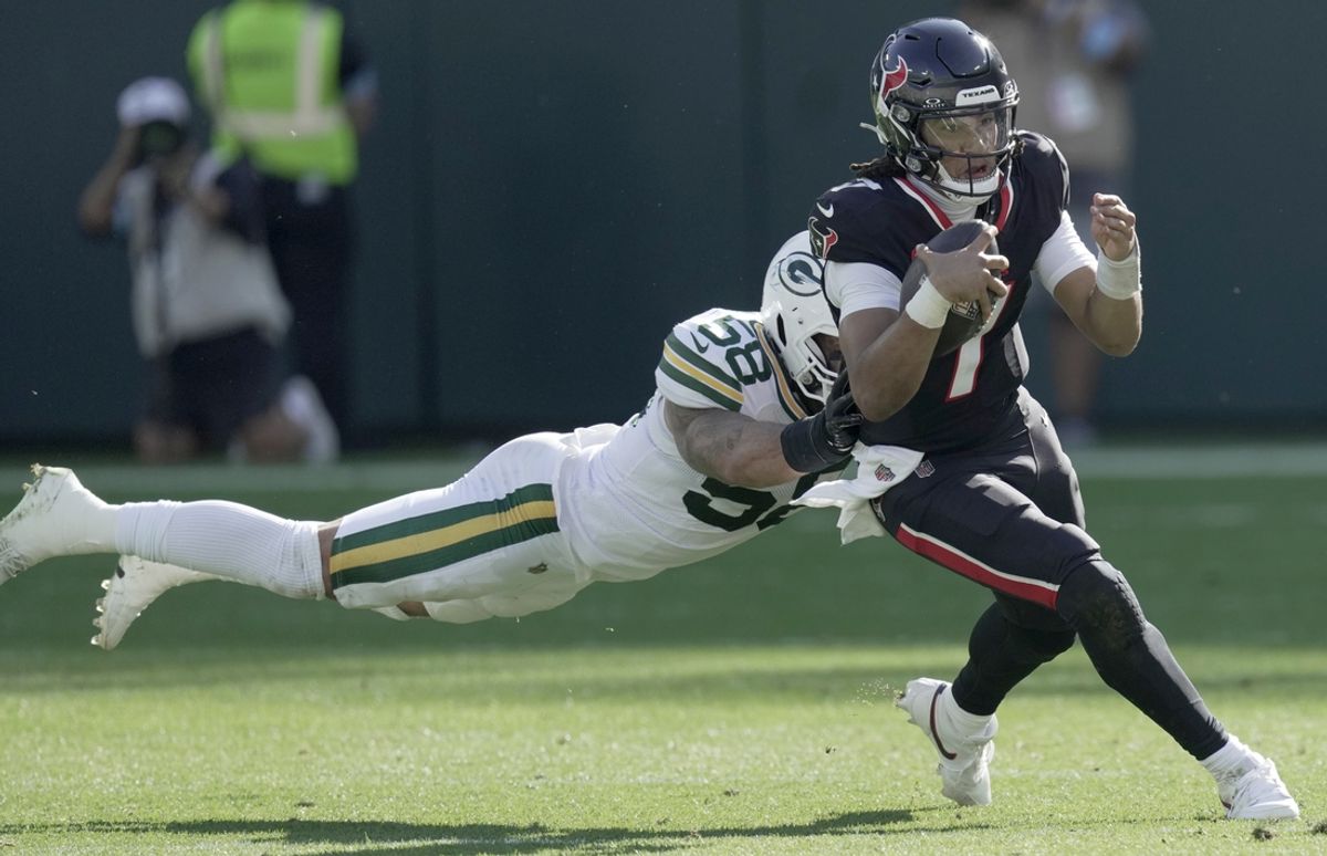 Oct 20, 2024; Green Bay, Wisconsin, USA; Green Bay Packers linebacker Isaiah McDuffie (58) tackles Houston Texans quarterback C.J. Stroud (7) during the fourth quarter of their game at Lambeau Field. Mandatory Credit: Mark Hoffman/Milwaukee Journal Sentinel via the USA TODAY NETWORK-Wisconsin-Imagn Images