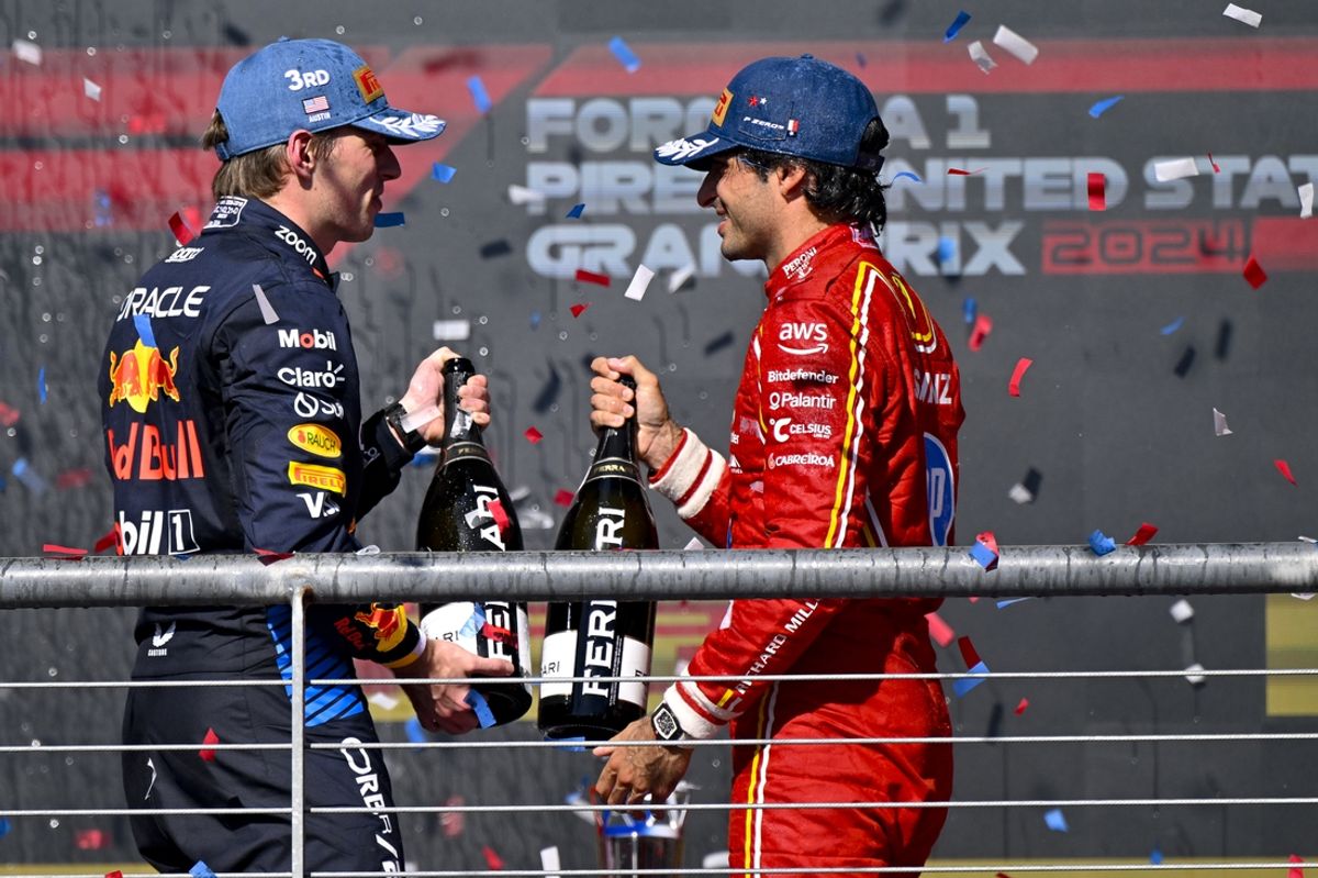 Oct 20, 2024; Austin, Texas, USA; Oracle Red Bull Racing driver Max Verstappen (left) of Team Netherlands and Scuderia Ferrari driver Carlos Sainz (right) of Team Spain celebrate on the podium after the 2024 Formula One US Grand Prix at Circuit of the Americas. Mandatory Credit: Jerome Miron-Imagn Images