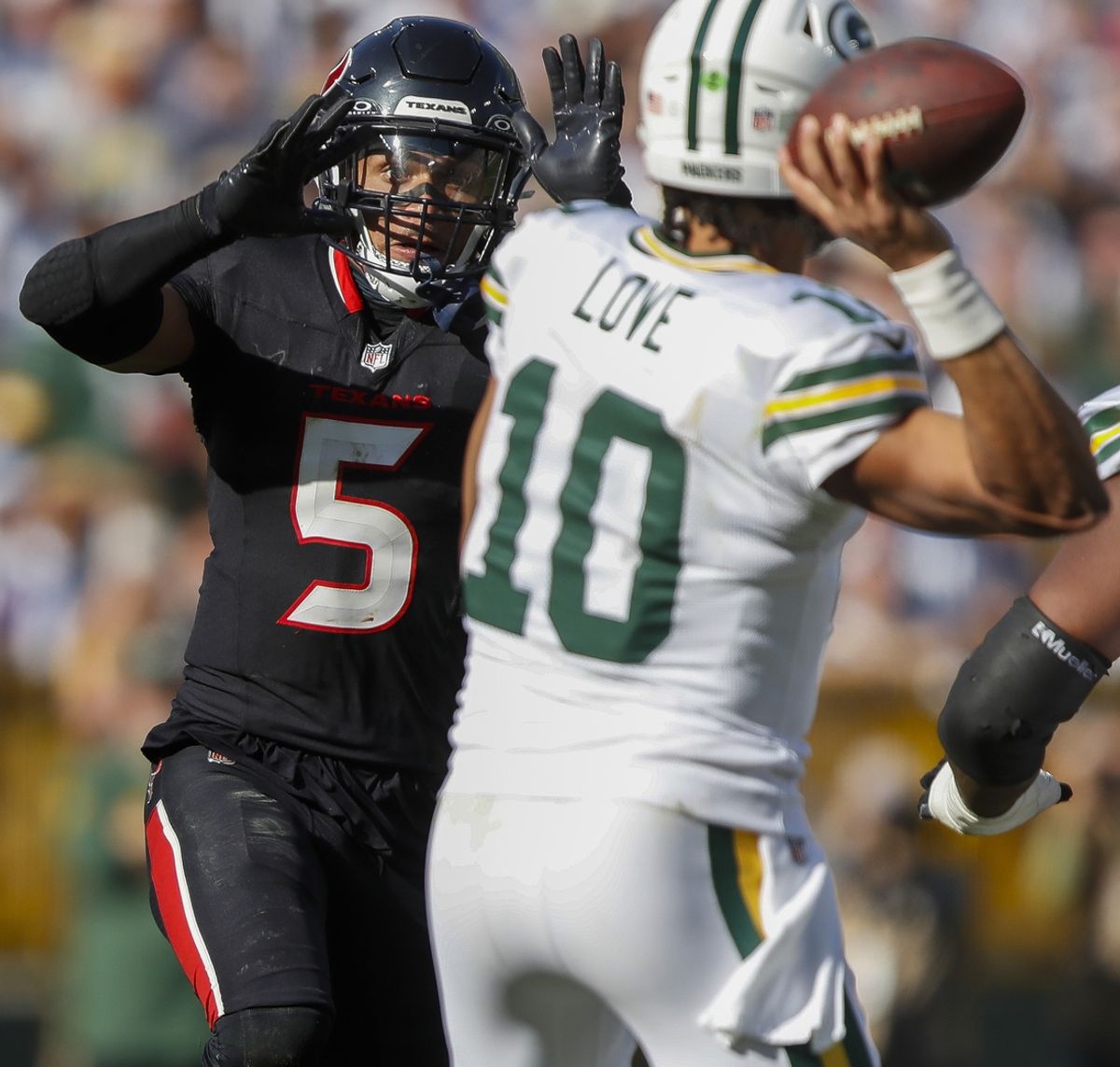 Oct 20, 2024; Green Bay, Wisconsin, USA;  Houston Texans safety Jalen Pitre (5) tries to bat down a pass as he closes in on Green Bay Packers quarterback Jordan Love (10)  at Lambeau Field. Mandatory Credit: Tork Mason/Green Bay Press-Gazette via the USA TODAY NETWORK-Wisconsin-Imagn Images