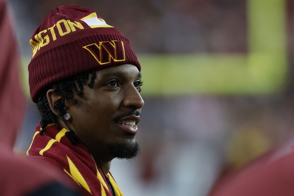 Oct 20, 2024; Landover, Maryland, USA; Injured Washington Commanders quarterback Jayden Daniels  looks on from the sidelines against the Carolina Panthers during the third quarter at Northwest Stadium. Mandatory Credit: Geoff Burke-Imagn Images