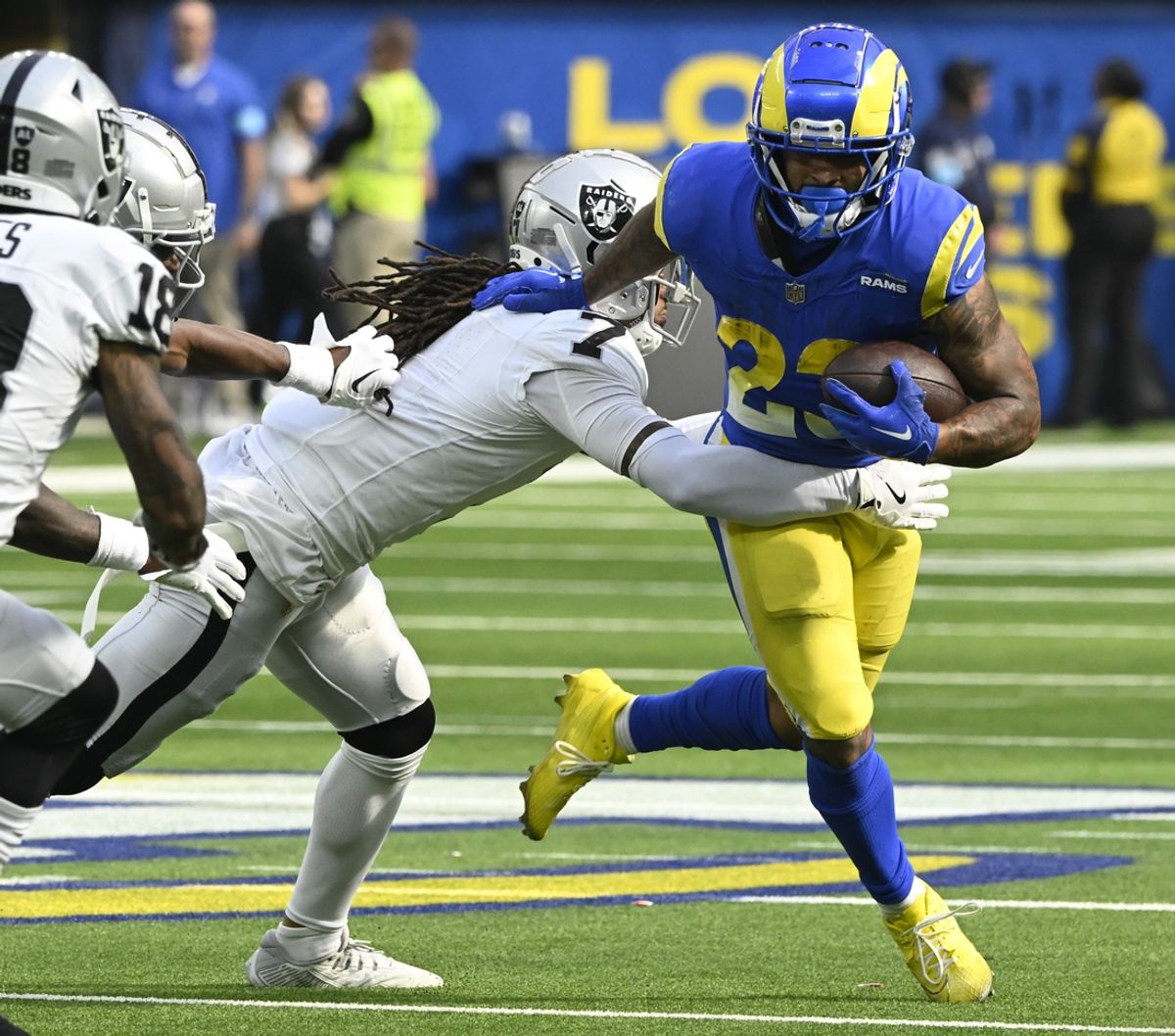 Oct 20, 2024; Inglewood, California, USA; Los Angeles Rams running back Kyren Williams (23) tries to break a tackle by Las Vegas Raiders safety Tre'von Moehrig (7) during the third quarter at SoFi Stadium. Mandatory Credit: Robert Hanashiro-Imagn Images