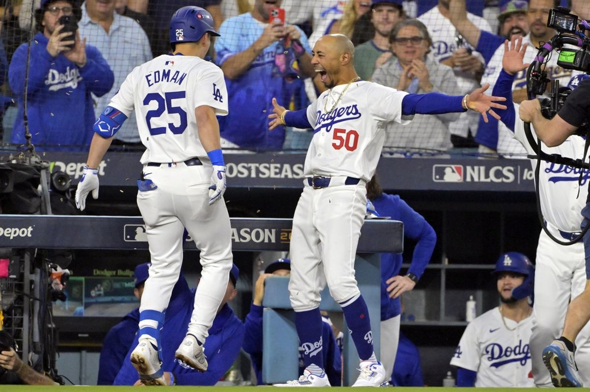 Oct 20, 2024; Los Angeles, California, USA; Los Angeles Dodgers shortstop Tommy Edman (25) celebrates with outfielder Mookie Betts (50) after hitting a two run home run in the third inning against the New York Mets during game six of the NLCS for the 2024 MLB playoffs at Dodger Stadium. Mandatory Credit: Jayne Kamin-Oncea-Imagn Images