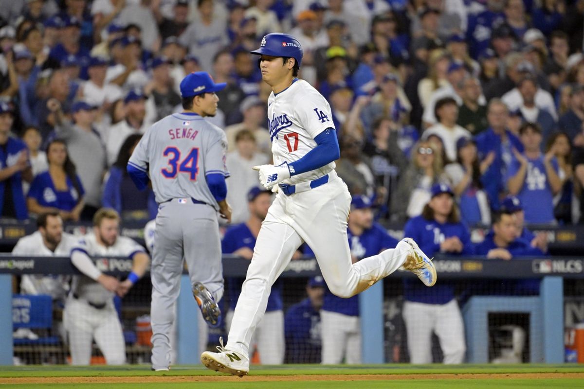 Oct 20, 2024; Los Angeles, California, USA; Los Angeles Dodgers designated hitter Shohei Ohtani (17) runs home to score on a sacrifice fly by outfielder Teoscar Hernandez (37) in the eighth inning against the New York Mets during game six of the NLCS for the 2024 MLB playoffs at Dodger Stadium. Mandatory Credit: Jayne Kamin-Oncea-Imagn Images