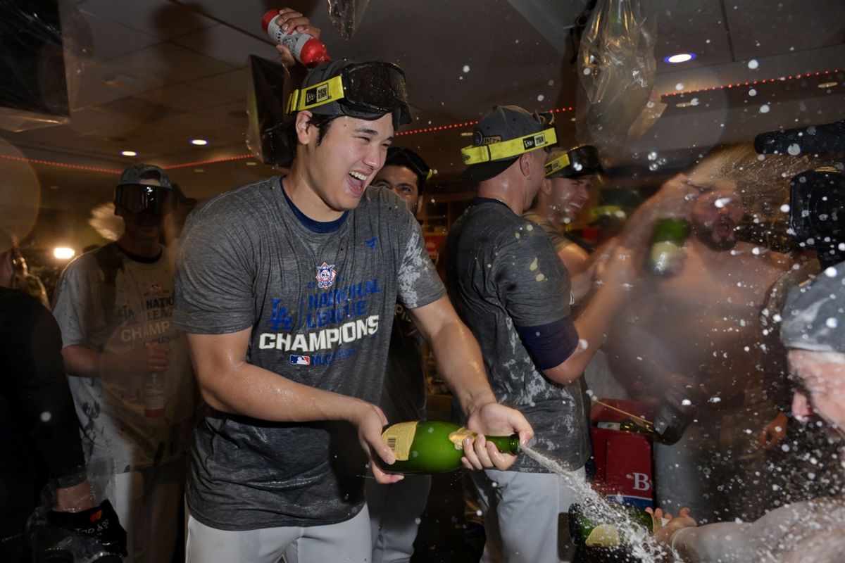 Oct 20, 2024; Los Angeles, California, USA; Los Angeles Dodgers designated hitter Shohei Ohtani (17) celebrates with champagne in the clubhouse after defeating the New York Mets in game six of the NLCS for the 2024 MLB playoffs at Dodger Stadium. Mandatory Credit: Jayne Kamin-Oncea-Imagn Images