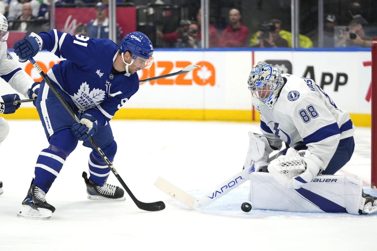 Oct 21, 2024; Toronto, Ontario, CAN;  Toronto Maple Leafs forward John Tavares (91) and Tampa Bay Lightning goaltender Andrei Vasilevskiy (88) battle for a loose puck during the first period at Scotiabank Arena. Mandatory Credit: John E. Sokolowski-Imagn Images