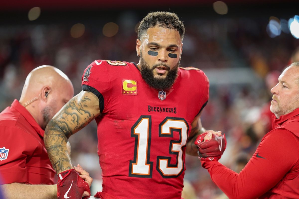 Oct 21, 2024; Tampa, Florida, USA; Tampa Bay Buccaneers wide receiver Mike Evans (13) is helped off the field by trainers against the Baltimore Ravens in the second quarter at Raymond James Stadium. Mandatory Credit: Nathan Ray Seebeck-Imagn Images