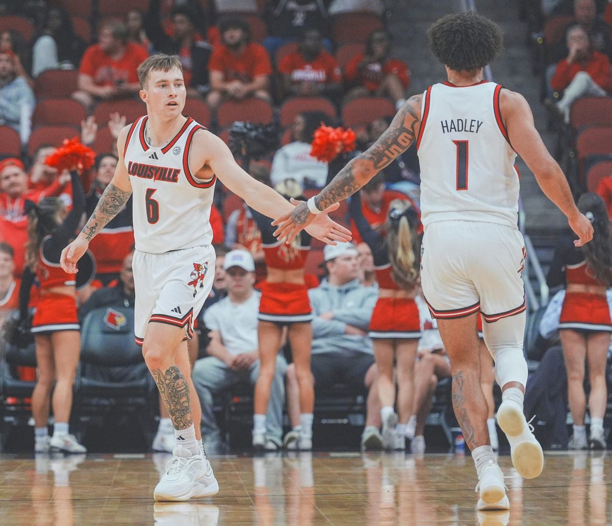 Louisville Cardinals guard Reyne Smith (6) and teammate J'Vonne Hadley (1) celebrate a play during the Young Harris College exhibition game at the KFC Yum! Center in downtown Louisville, Ky. Oct. 21, 2024.