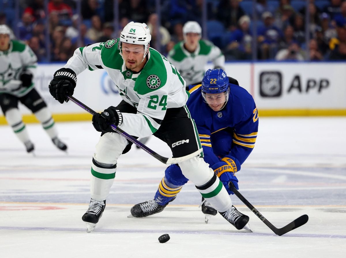 Oct 22, 2024; Buffalo, New York, USA;  Dallas Stars center Roope Hintz (24) skates up ice with the puck as Buffalo Sabres right wing Jack Quinn (22) tries to defend during the first period at KeyBank Center. Mandatory Credit: Timothy T. Ludwig-Imagn Images