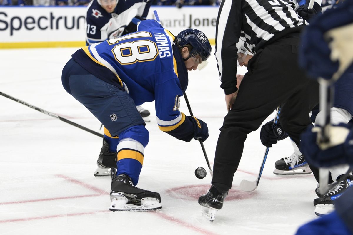 Oct 22, 2024; St. Louis, Missouri, USA; St. Louis Blues center Robert Thomas (18) takes a face-off against the Winnipeg Jets during the first period at Enterprise Center. Mandatory Credit: Jeff Le-Imagn Images