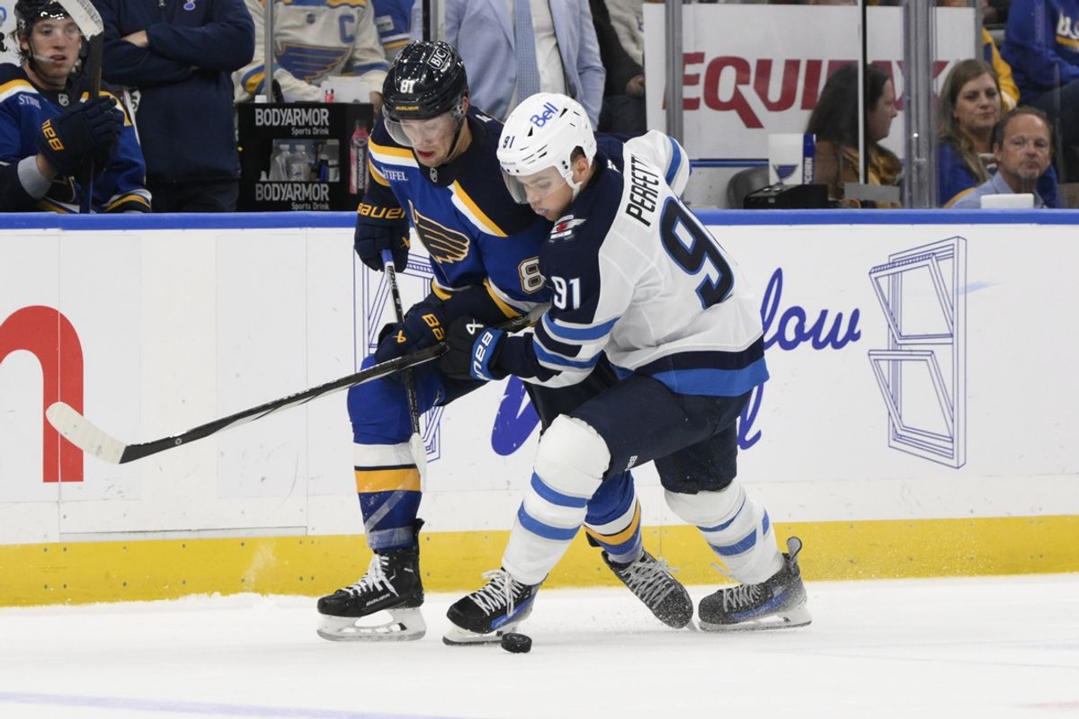 Oct 22, 2024; St. Louis, Missouri, USA; Winnipeg Jets center Cole Perfetti (91) battles St. Louis Blues center Dylan Holloway (81) during the first period at Enterprise Center. Mandatory Credit: Jeff Le-Imagn Images