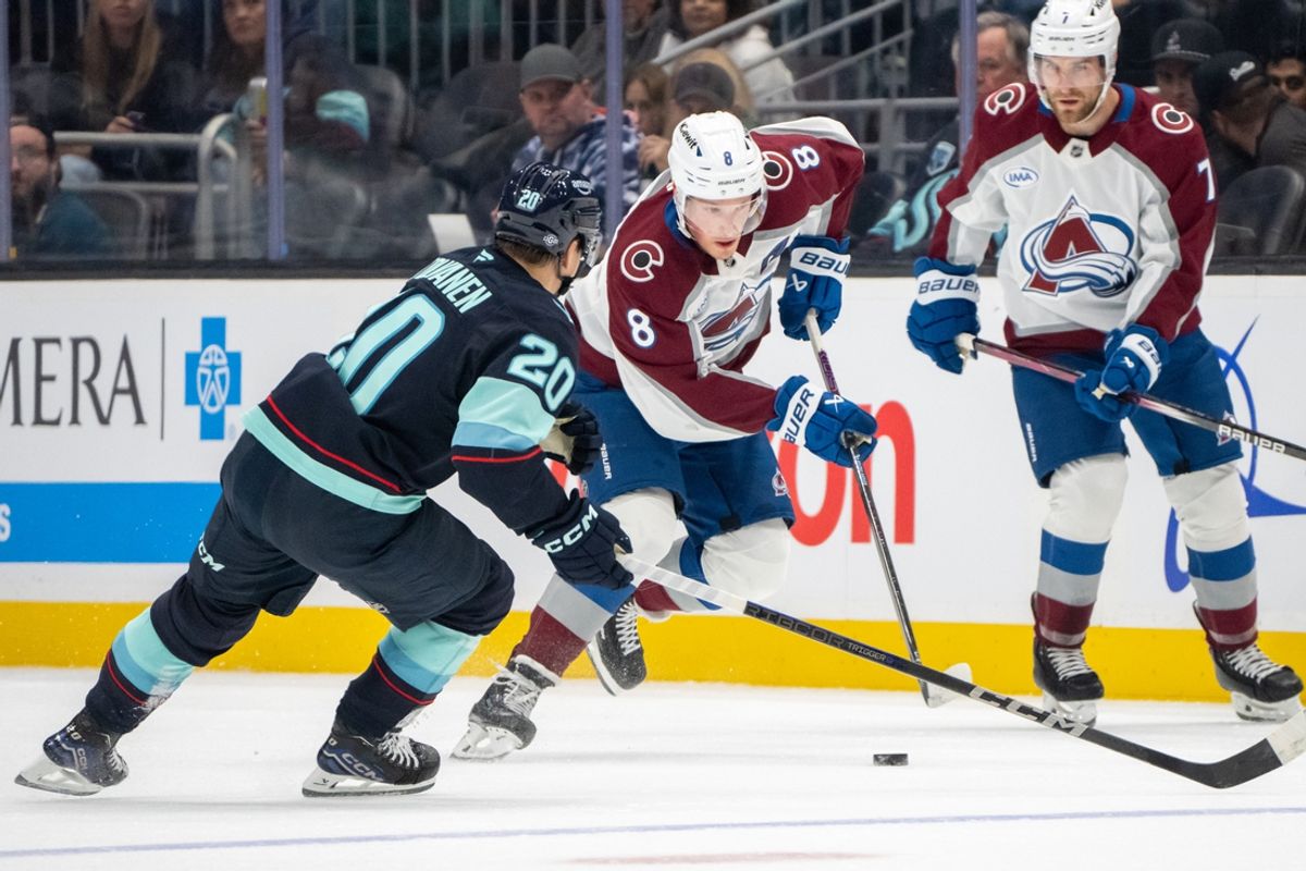 Oct 22, 2024; Seattle, Washington, USA;  Colorado Avalanche defenseman Cale Makar (8) skates against Seattle Kraken forward Eeli Tolvanen (20) during the first period at Climate Pledge Arena. Mandatory Credit: Stephen Brashear-Imagn Images