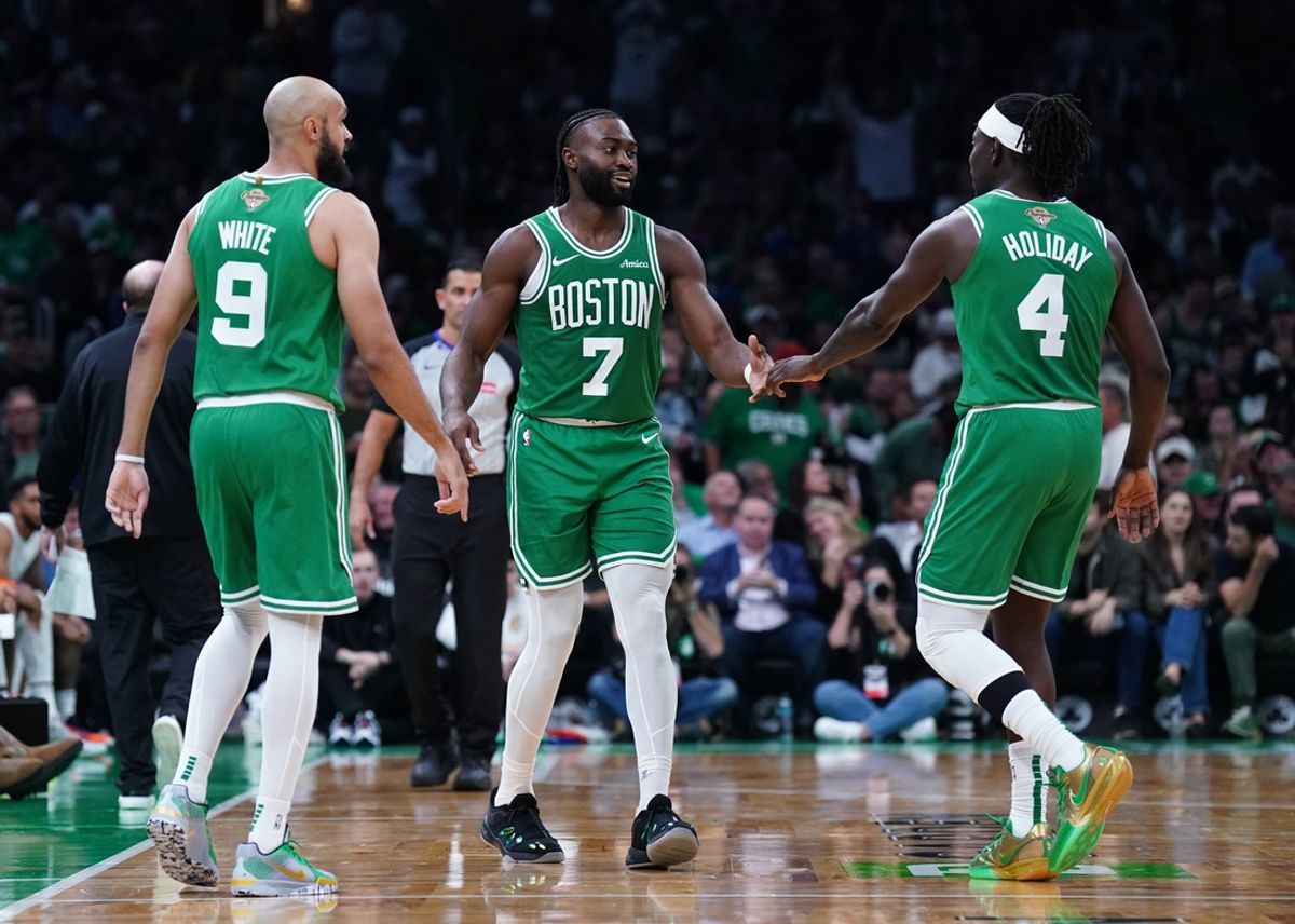 Oct 22, 2024; Boston, Massachusetts, USA; Boston Celtics guard Jaylen Brown (7), guard Jrue Holiday (4) and guard Derrick White (9) react after a play against the New York Knicks in the second half at TD Garden. Mandatory Credit: David Butler II-Imagn Images