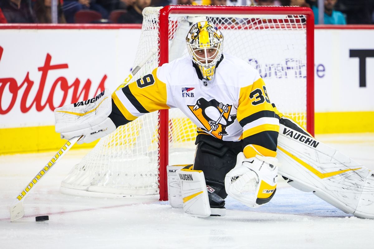 Oct 22, 2024; Calgary, Alberta, CAN; Pittsburgh Penguins goaltender Alex Nedeljkovic (39) controls the puck against the Calgary Flames during the second period at Scotiabank Saddledome. Mandatory Credit: Sergei Belski-Imagn Images