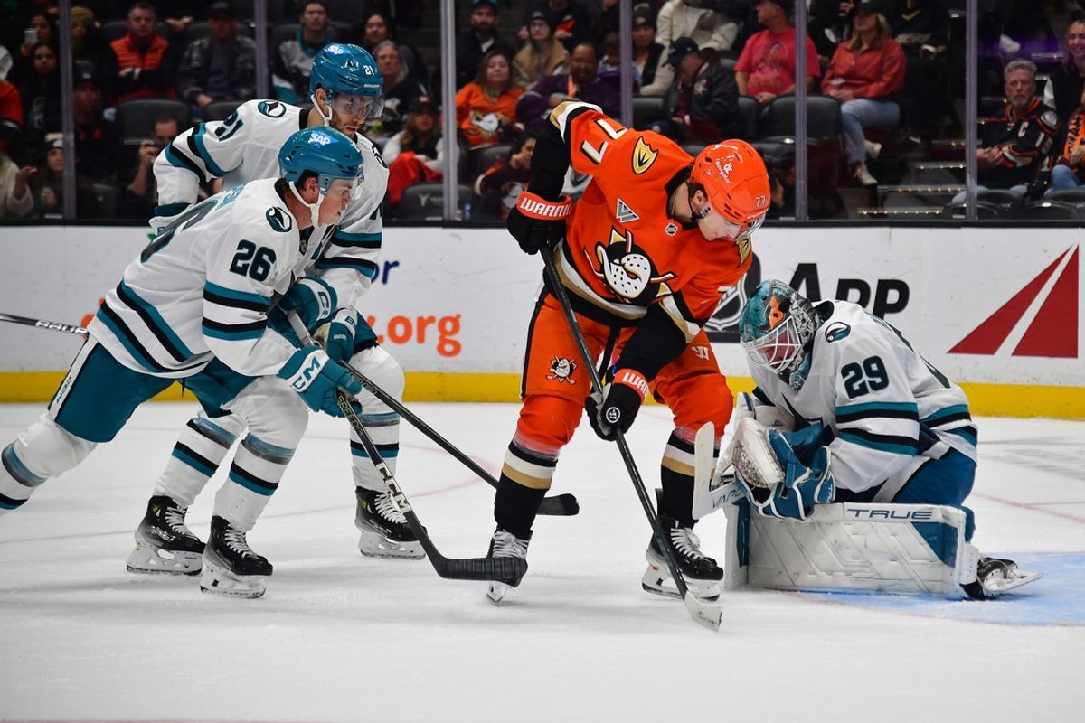 Oct 22, 2024; Anaheim, California, USA; San Jose Sharks goaltender Mackenzie Blackwood (29) blocks a shot against Anaheim Ducks right wing Frank Vatrano (77) as defenseman Jack Thompson (26) helps defend during the second period at Honda Center. Mandatory Credit: Gary A. Vasquez-Imagn Images