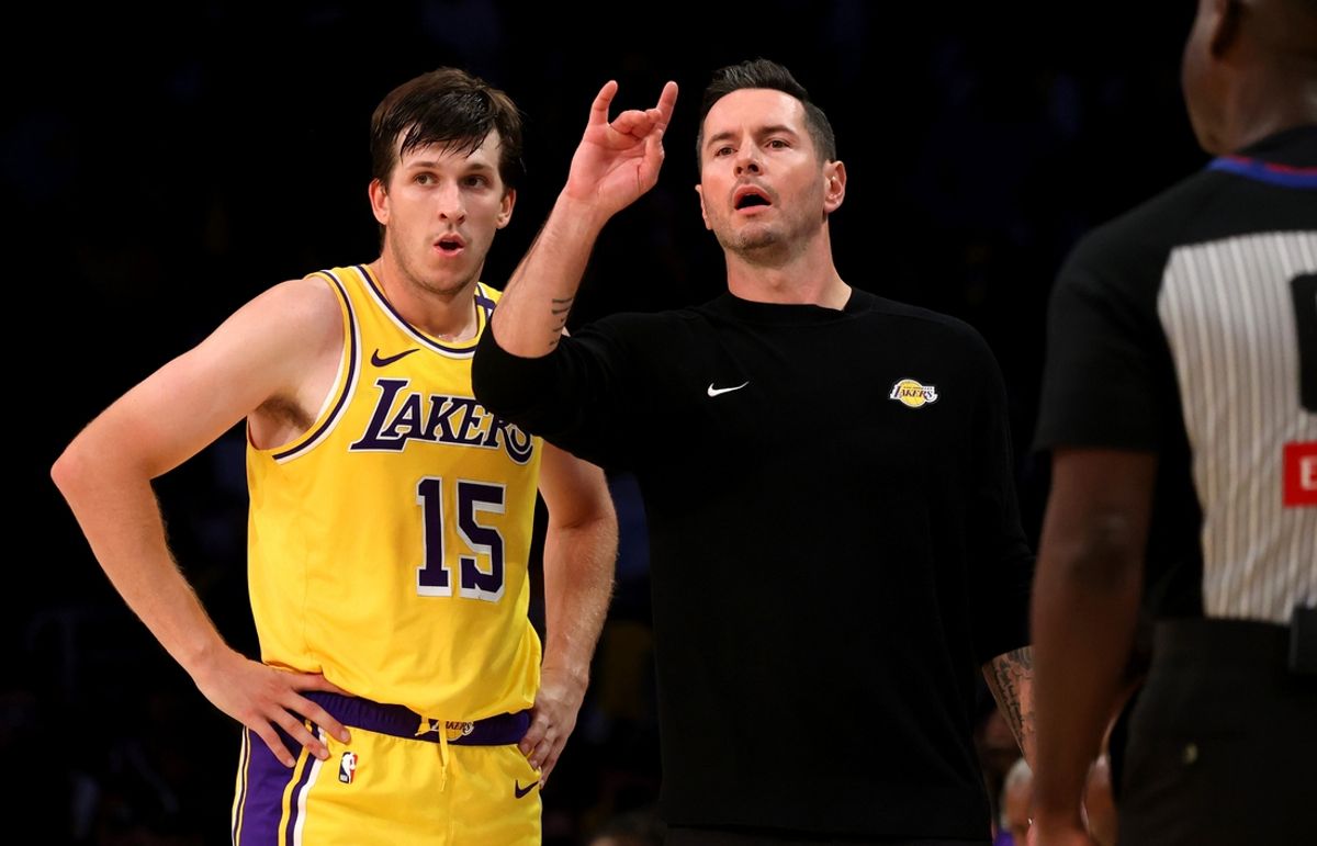 Oct 22, 2024; Los Angeles, California, USA; Los Angeles Lakers head coach JJ Redick signals a play beside guard Austin Reaves (15) during the fourth quarter against the Minnesota Timberwolves at Crypto.com Arena. Mandatory Credit: Jason Parkhurst-Imagn Images