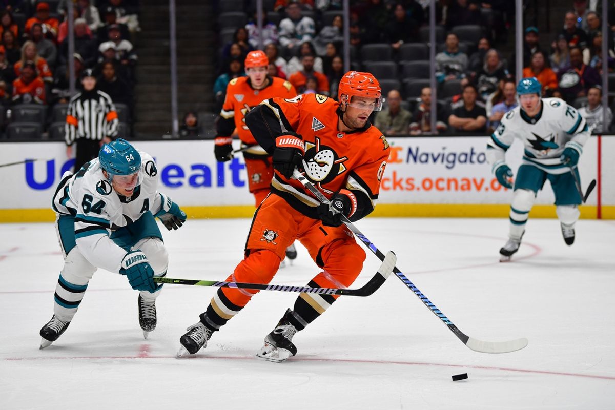 Oct 22, 2024; Anaheim, California, USA; San Jose Sharks center Mikael Granlund (64) plays for the puck against Anaheim Ducks defenseman Brian Dumoulin (6) during the third period at Honda Center. Mandatory Credit: Gary A. Vasquez-Imagn Images