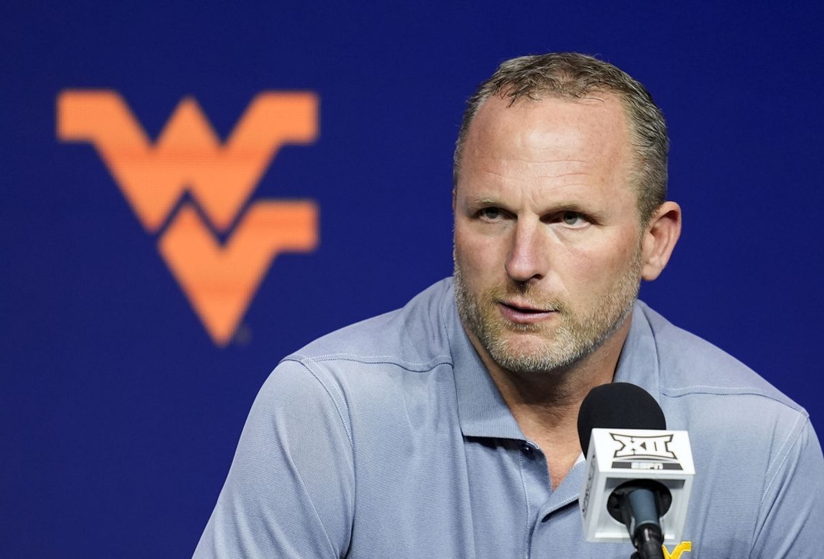 Oct 23, 2024; Kansas City, MO, USA; West Virginia Mountaineers head coach Darian DeVries talks to media during the Big 12 Men’s Basketball Media Day at T-Mobile Center. Mandatory Credit: Jay Biggerstaff-Imagn Images