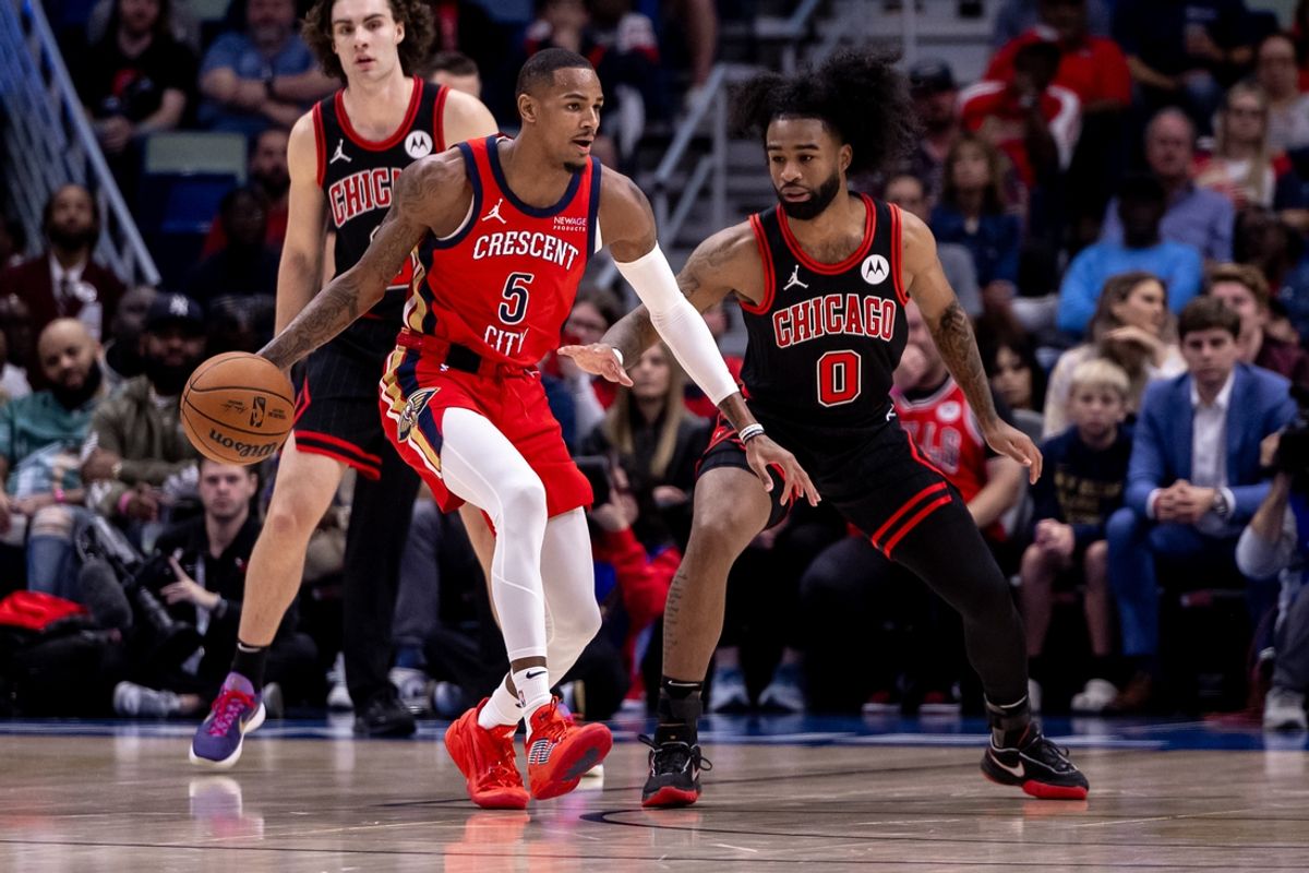 Oct 23, 2024; New Orleans, Louisiana, USA;  New Orleans Pelicans guard Dejounte Murray (5) dribbles against Chicago Bulls guard Coby White (0) during the first half at Smoothie King Center. Mandatory Credit: Stephen Lew-Imagn Images
